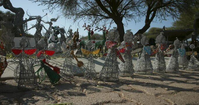 Botswana, Gaborone, Phakalane , African art displaying wire art sculptures at a flea market
