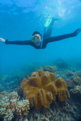 woman using a stinger suit in the great barrier reef in summer time .