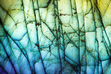 This is a macro photo of a colorful blue and green labradorite stone.  I used special lighting to bring out the saturated cool colors and cracked mineral textures.