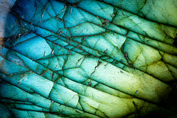 This is a macro photo of a colorful blue and green labradorite stone.  I used special lighting to bring out the saturated cool colors and cracked mineral textures.