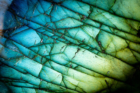 This is a macro photo of a colorful blue and green labradorite stone.  I used special lighting to bring out the saturated cool colors and cracked mineral textures.
