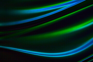 Wavy streak of blues and greens in chrome with black background asset