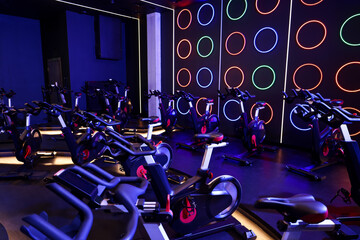 Many exercise bikes in fitness club. Indoor cycling class