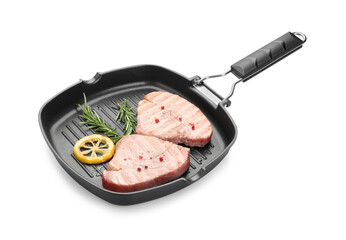 Grill pan with delicious tuna steaks, lemon and rosemary on white background