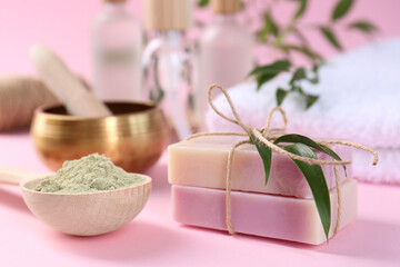 Retreat concept. Soap bars and spirulina powder on pink background