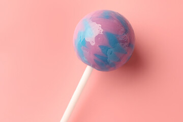 Tasty lollipop on pink background, top view