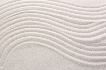 Fototapeta na wymiar White sand with pattern as background, closeup. Concept of zen and harmony