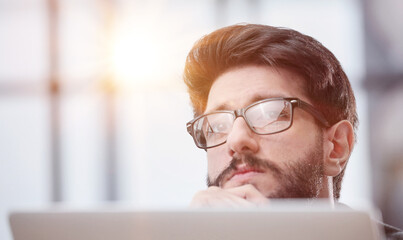 Businessman using a laptop while working late in his office