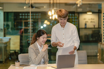 Asian man and woman meeting Asian Business Consultants to analyze and discuss financial report situation with digital tablet in conference room. investment advisor, collaboration concept