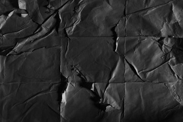 Peeled crumpled black poster paper texture background