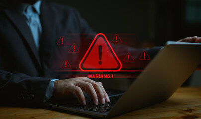 Businessman, IT staff, programmer, developer using computer with triangle caution warning sign for notification error and maintenance concept. System warning error popup and maintenance showing. - obrazy, fototapety, plakaty
