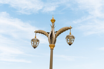 Fototapeta na wymiar A decorative metal street lamp stands at the entrance to the presidential palace - Qasr Al Watan in Abu Dhabi city, United Arab Emirates