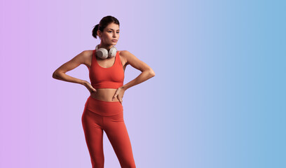 Fit sportswoman standing with hands on waist