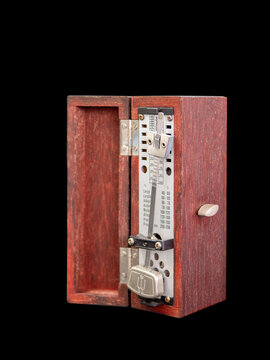 An old fashioned metronome ,made from wood box, black background, Selective focus