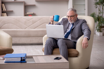 Old male boss working from home during pandemic