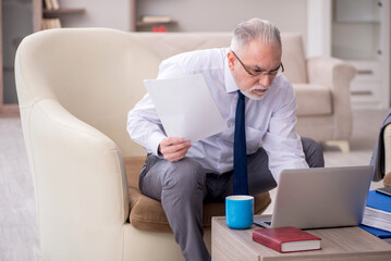 Old male boss working from home during pandemic
