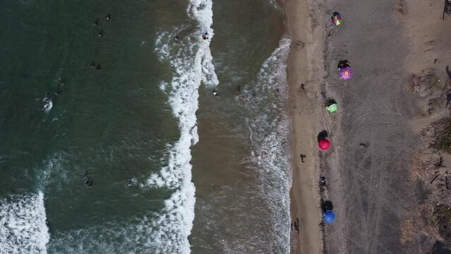 Aerial view of the beach, top view of waves crashing on the beach. Sea waves. Beautiful sandy beach. Beautiful aerial beach, bird's eye view, drone view, Sparkling waves Top-down aerial shot, 4K