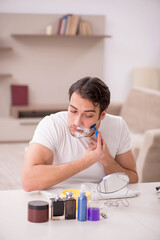 Obraz premium Young man shaving face at home