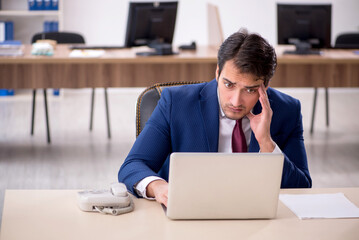 Young male employee working in the office