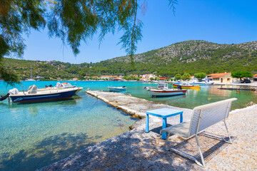 Fototapeta na wymiar Small fishing village of Posidonio with turquoise blue Aegean sea on Samos island, Greece