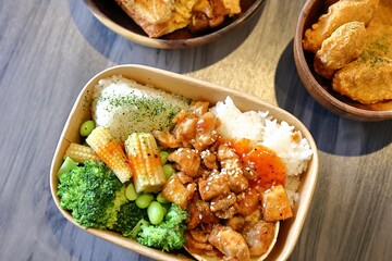 Delicious Taiwanese three cup chicken bento on wooden table
