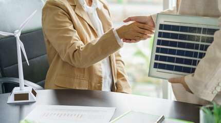 Handshake and business with solar panels green energy Business people working in green eco friendly...