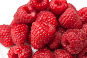 Delicious fresh ripe raspberries on white background