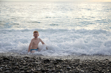 Happy child playing on the ocean. children's vacation, vacation