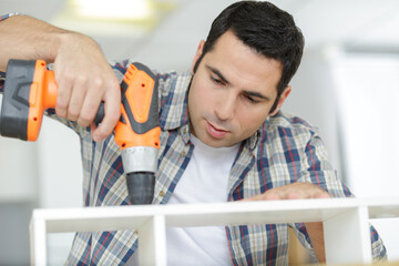 a man is assembling furniture