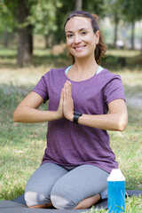 young woman doing yoga in morning park