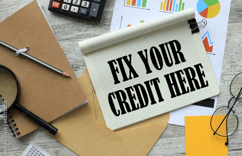 Poster fix your credit here symbol. magnifying glass on a notepad.text on the page on the background of fin
