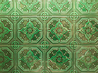 ceramic tile texture full frame. green geometric flower pattern on mosaic tiles, wall, background