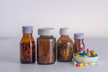  3 bottles of medicine without labels  with medicine cup on a white background