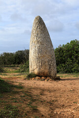 The Menhir do Padrao in Portugal surrounded by vegetation
