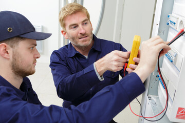 electrician checking a fuse box