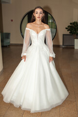 Obraz premium Fashion young bride in stylish wedding dress outdoor