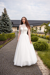 Fashion young bride in stylish wedding dress outdoor