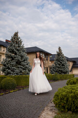 Fashion young bride in stylish wedding dress outdoor