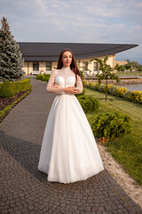 Fashion young bride in stylish wedding dress outdoor