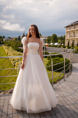 Fashion young bride in stylish wedding dress outdoor