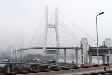 Fotobehang Nanpubrug Iconic Nanpu Bridge Draped in Fog, Overlooking the Cityscape