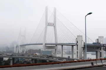 Fotobehang Nanpubrug Cityscape Through Fog: Nanpu Bridge and Skyline in Shanghai