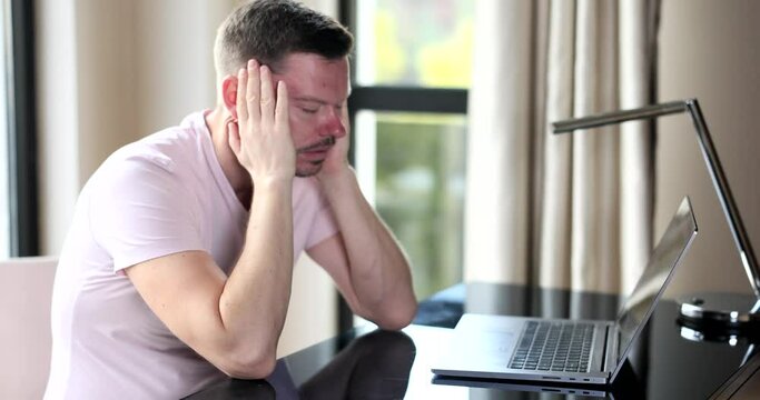 Sick young office worker freelancer feeling tired and overworked. Exhausted manager suffering from headache