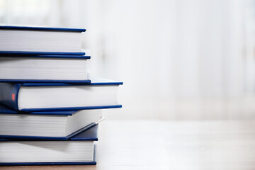 Stack of books on table with copy space. Books background for business and education design, back to school concept.
