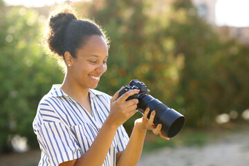 Happy photographer checking camera