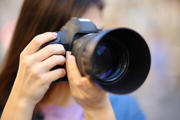 Photographer taking photo with camera outside - obrazy, fototapety, plakaty