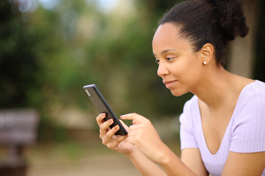 Profile of a black woman using smart phone