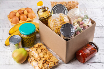 Food donation box. Pasta, cereals, various canned food in a carboard box. National food bank day or...