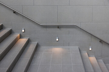 Stainless steel handrail on the office stone wall.