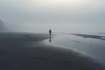 Foto op Plexiglas A lone individual on a misty beach symbolizes feelings of isolation and introspection often associated with depression © Davivd